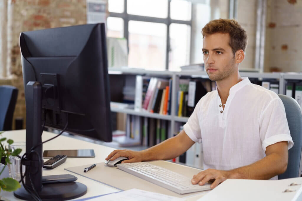 man works on monitor