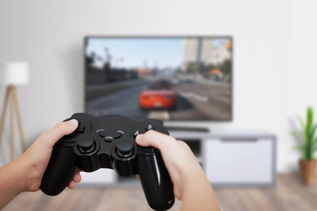 boy plays a game with controller on television