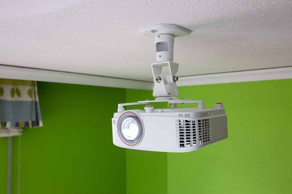 A projector on the ceiling saves space and is always correctly aligned.
