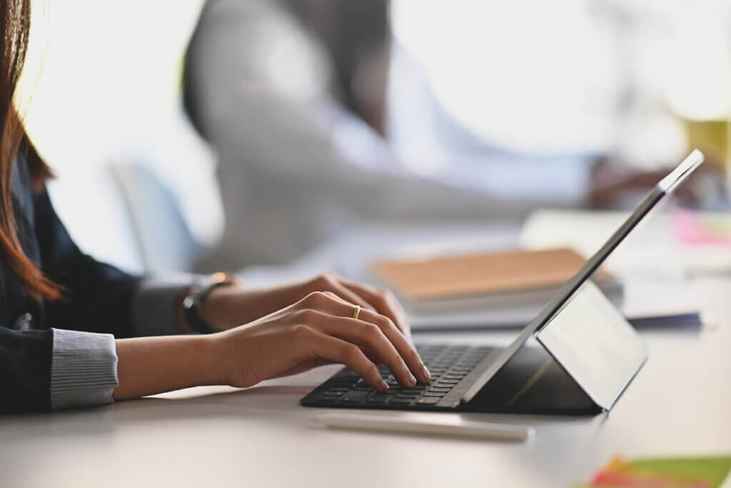 woman using tablet with keyboard