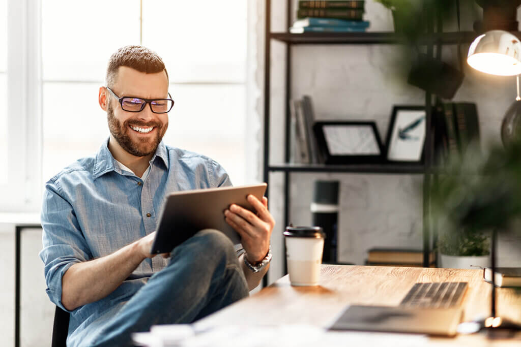 young man with tablet in office