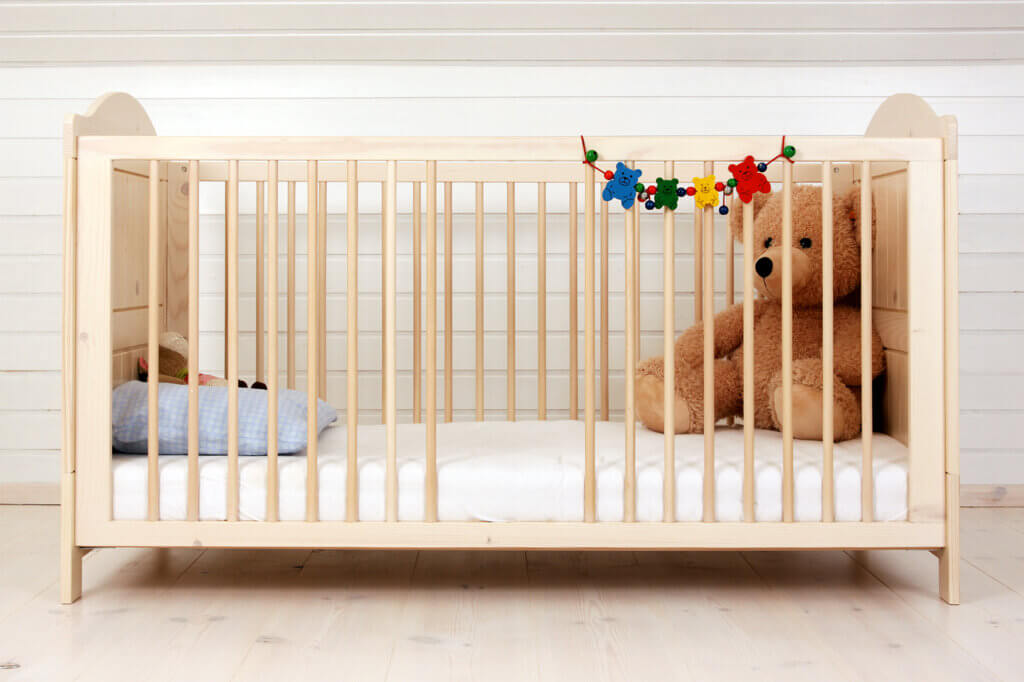 Teddy in the baby cot