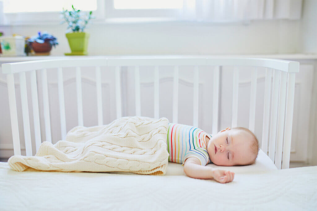 Baby sleeps in the cot