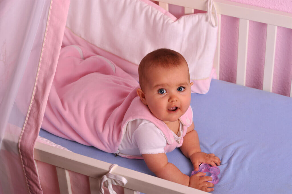Baby in cot looking up