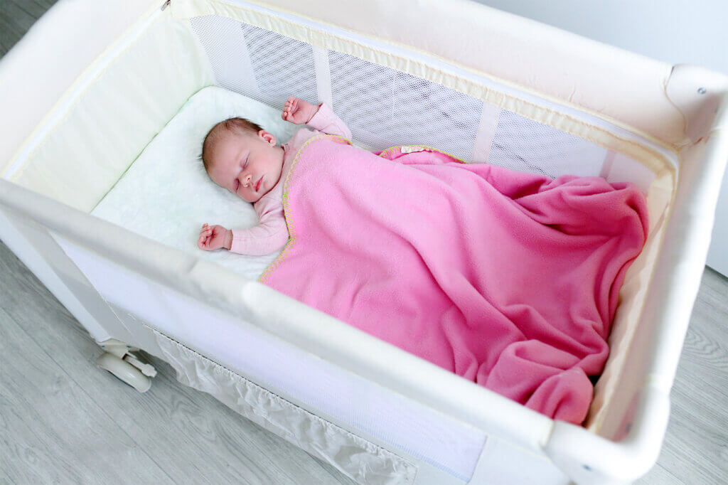 Baby with pink blanket