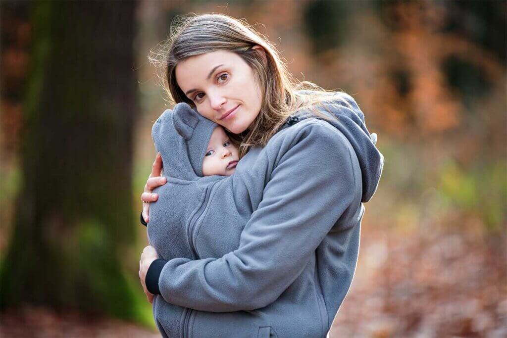 mother_carrying_baby_inside_jumper