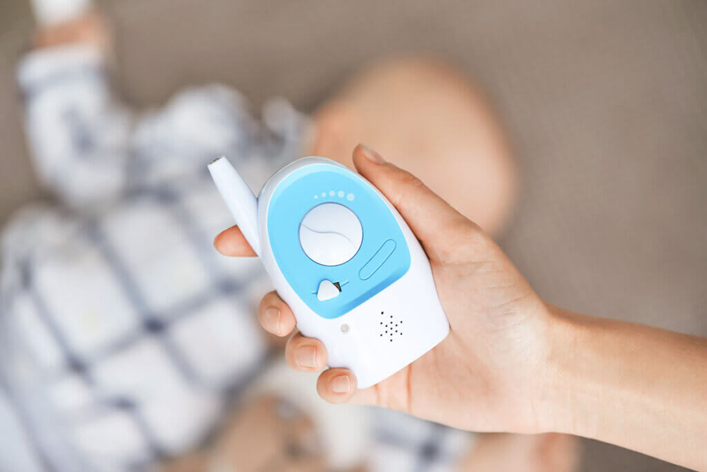  Woman holds baby monitor