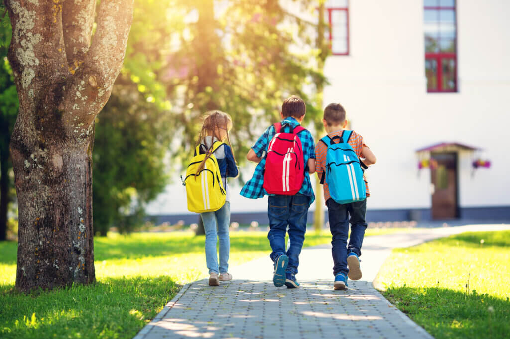 3 Children with school backpacks