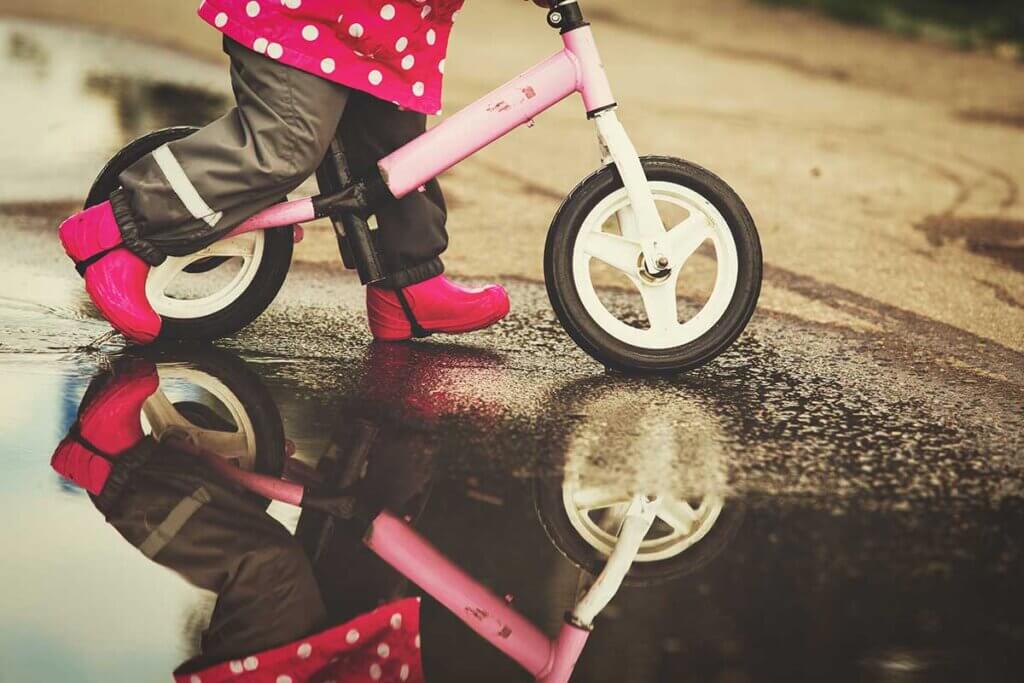 Child rides through wet track