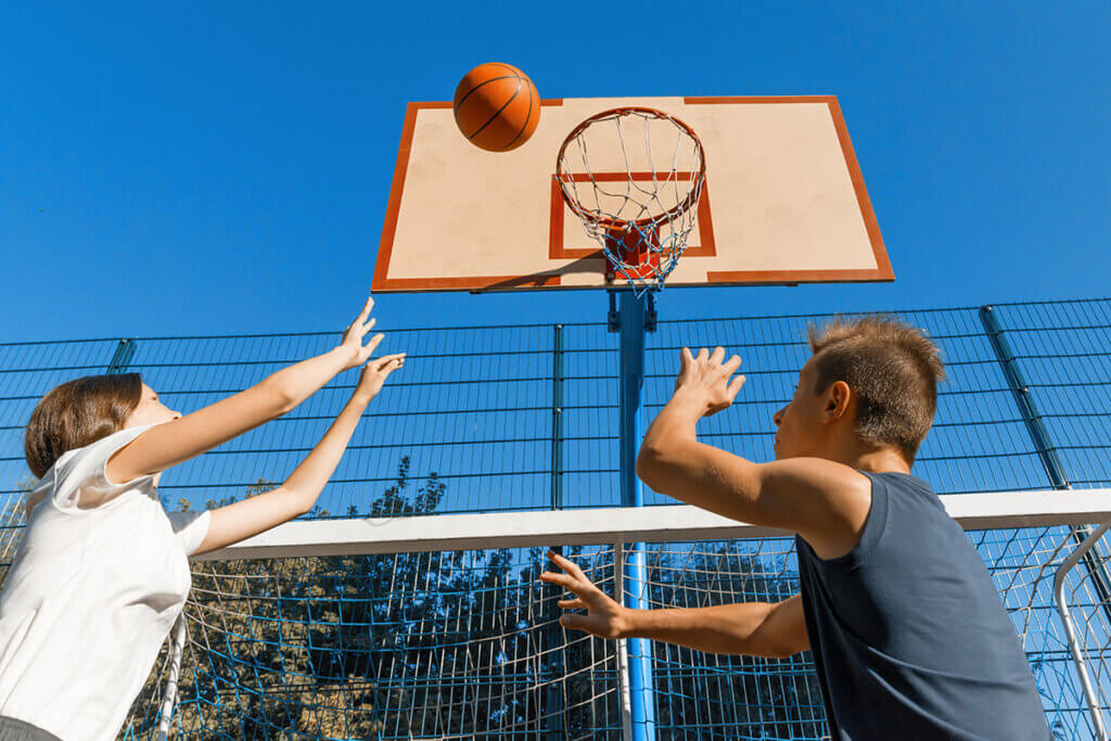 two people play basketball
