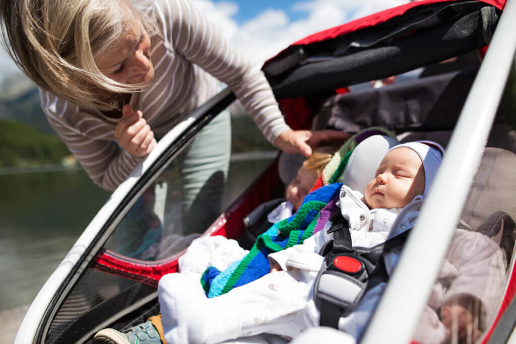 Baby sleeping in bicycle trailer