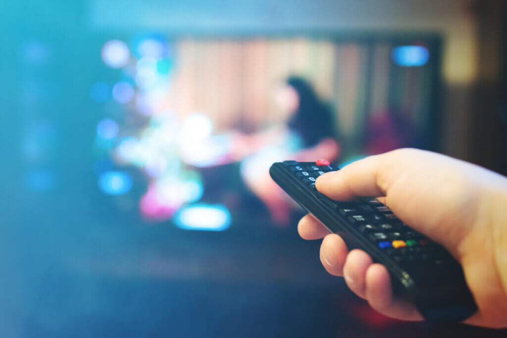 blu ray player person shows remote control on tv
