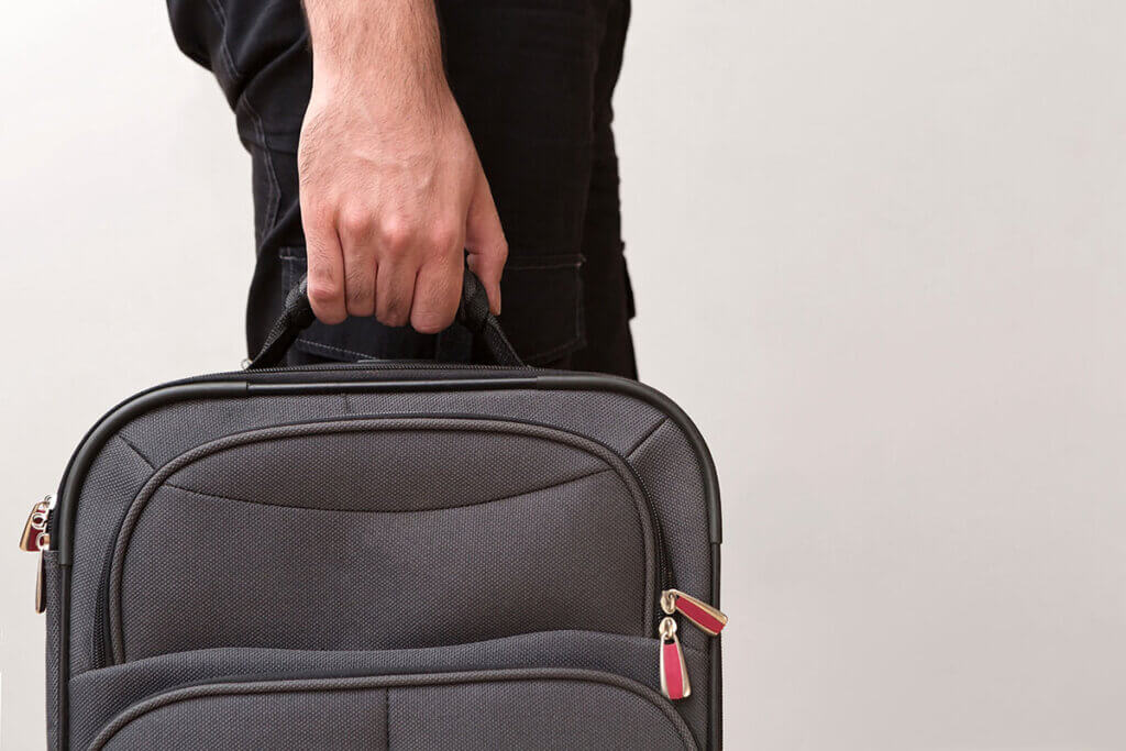 Man carries suitcase