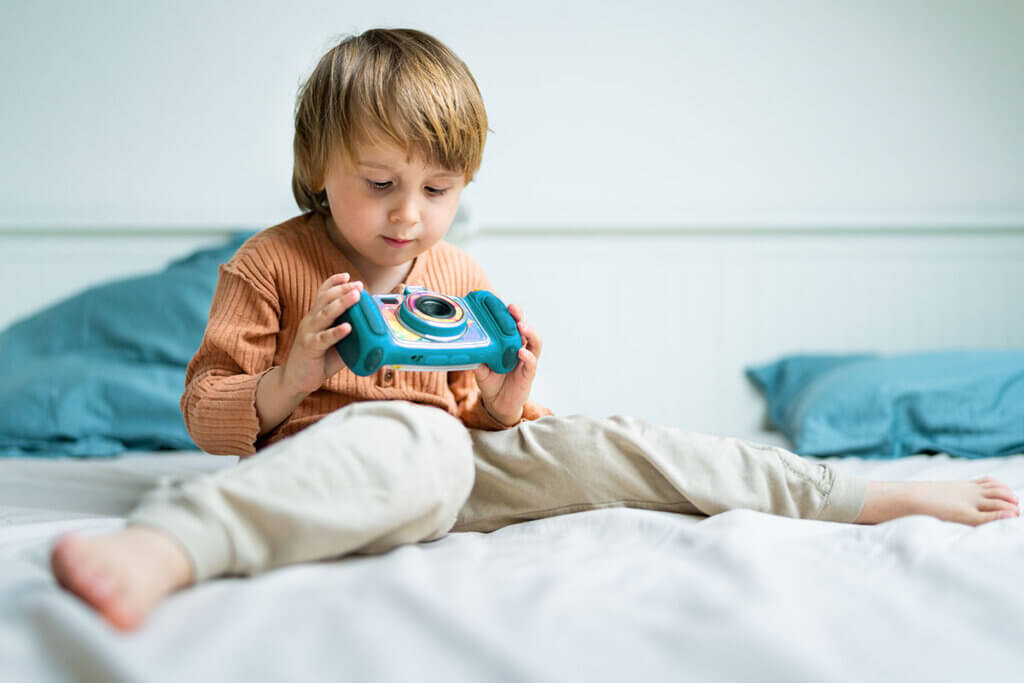 child plays with camera