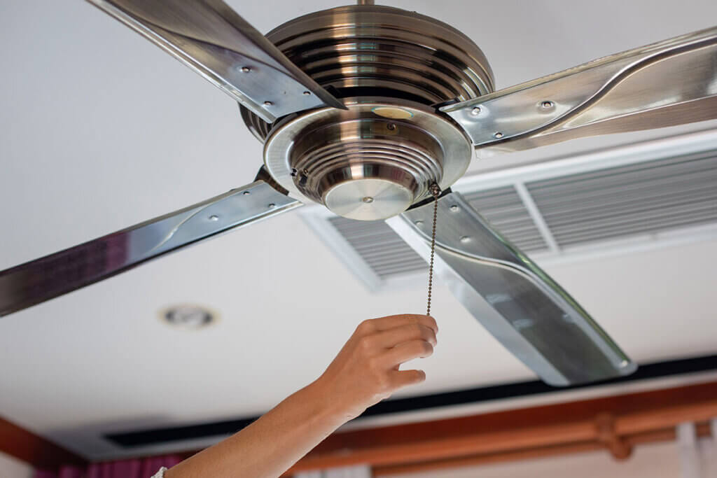 Metal ceiling fan is switched on