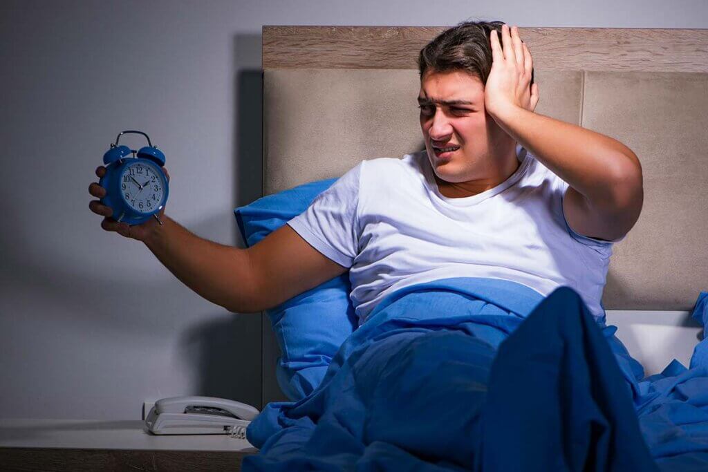 clock radio man wakes up annoyed by alarm