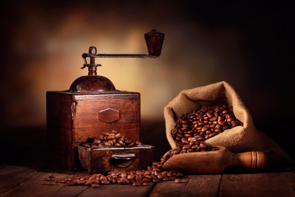 old coffee grinder and bag of coffee beans