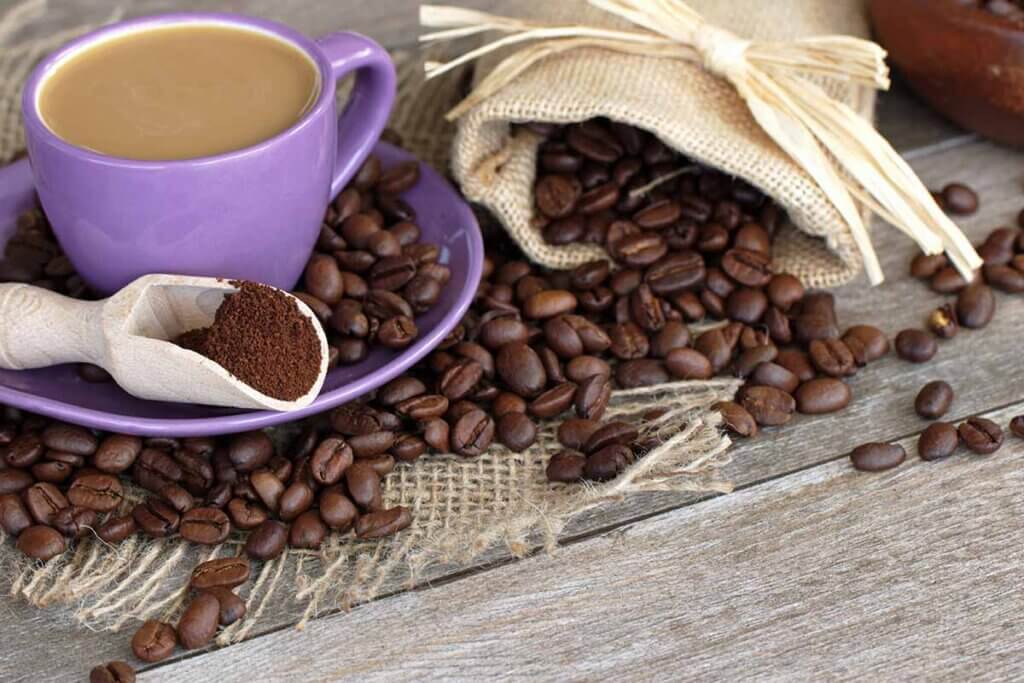 cup of coffee and coffee beans on wooden table