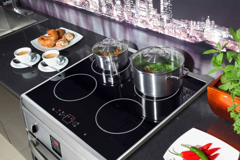 Two pots standing on cooker