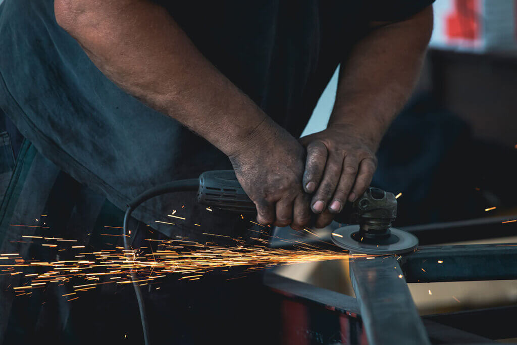 Angle grinder is guided with two hands