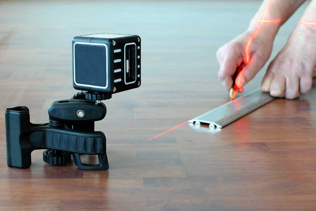 man marking the floor with laser