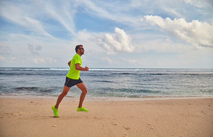 man jogging on the beach
