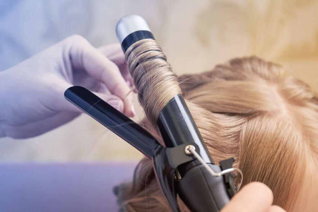curling iron application on blonde hair