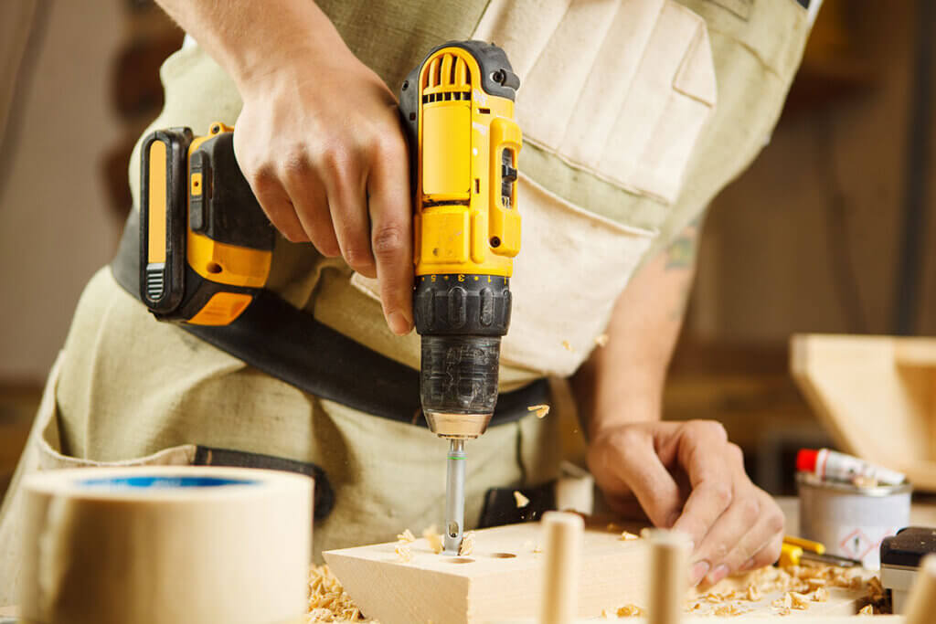 person drilling a hole