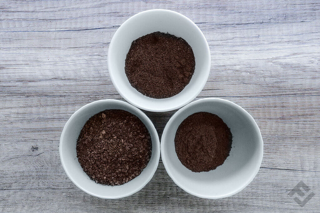 The cups filled with different grinds of coffee beans.