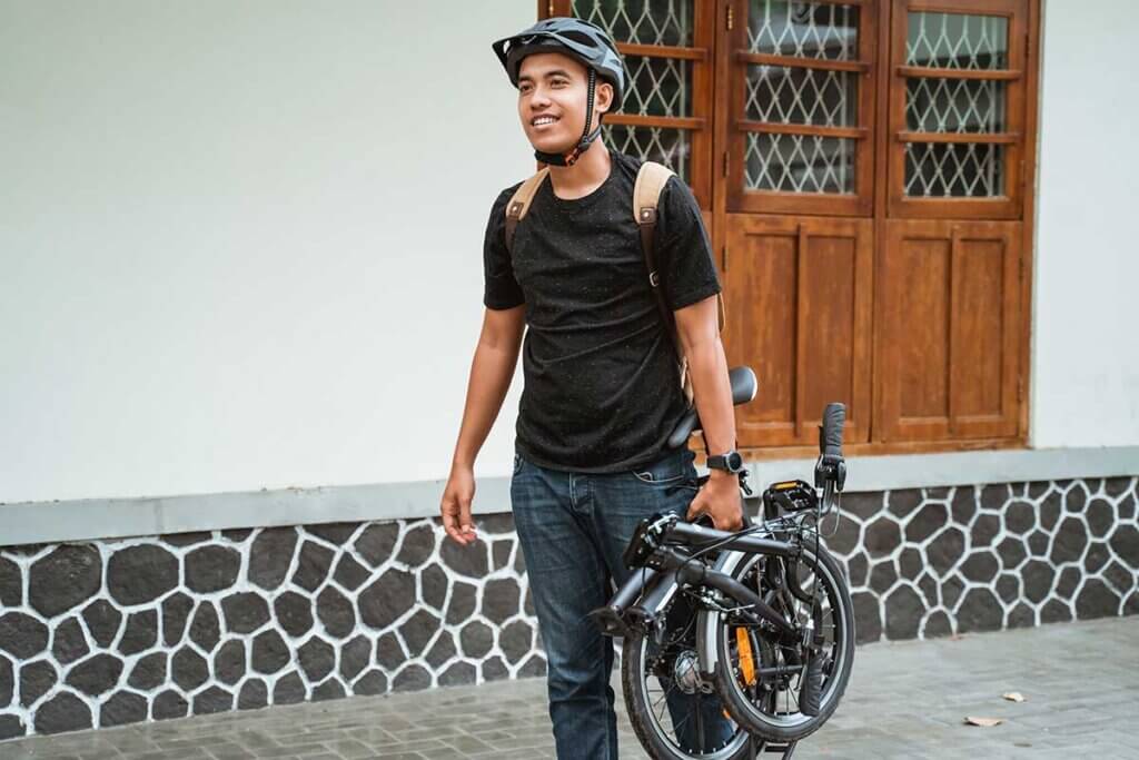 man_carrying_folded_bike