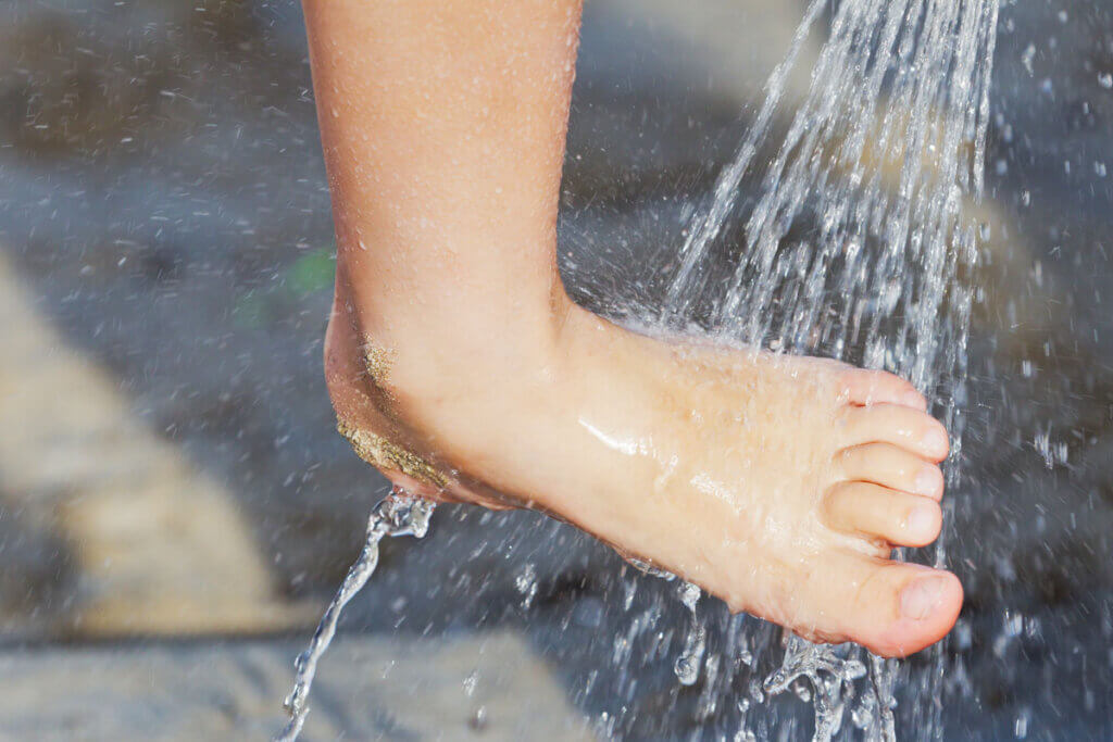 Foot being washed under shower