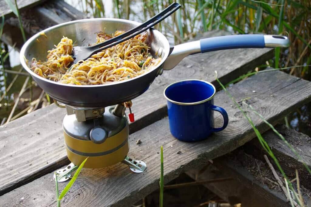 Preparing lunch on a camping cooker