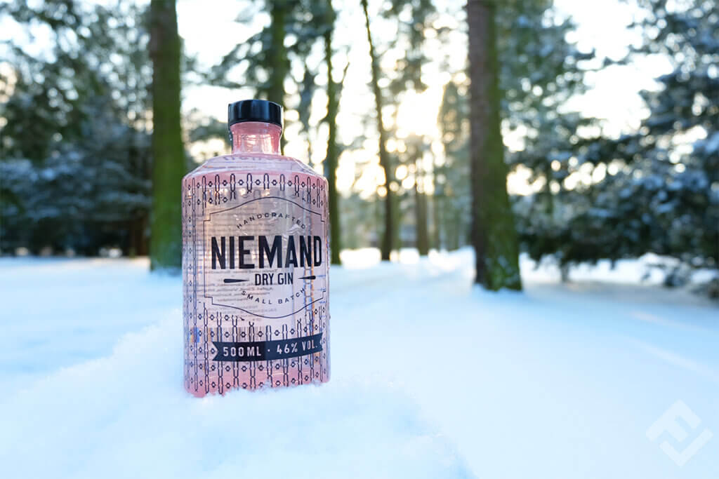 Bottle of Niemand Gin in a snowy forest