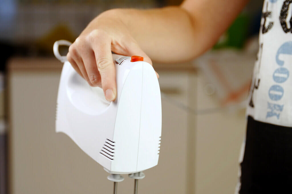 Woman holding hand mixer