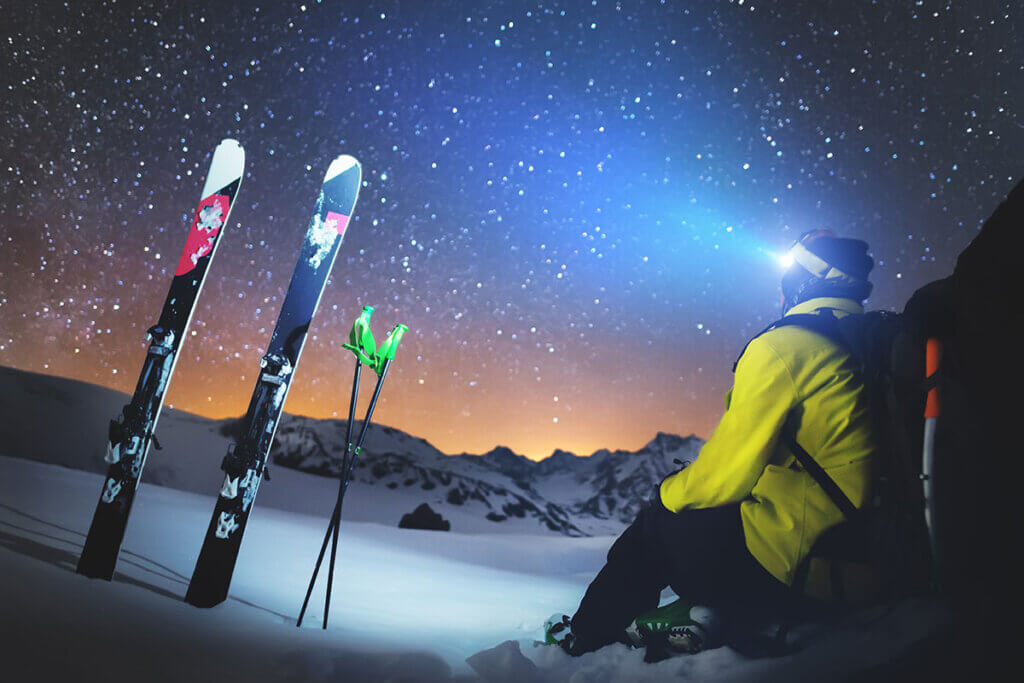 Skiers with head torch