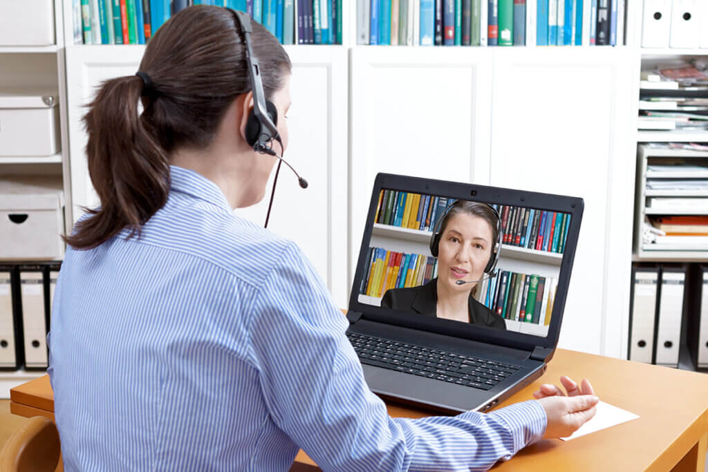 woman with headset at online meeting