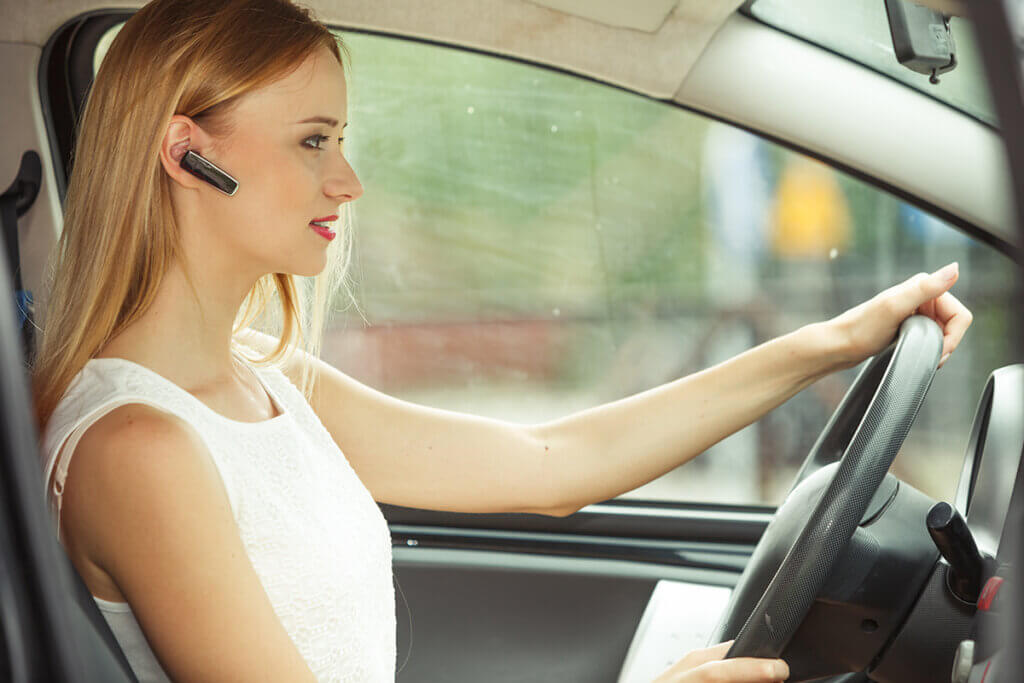 woman with headset in the car