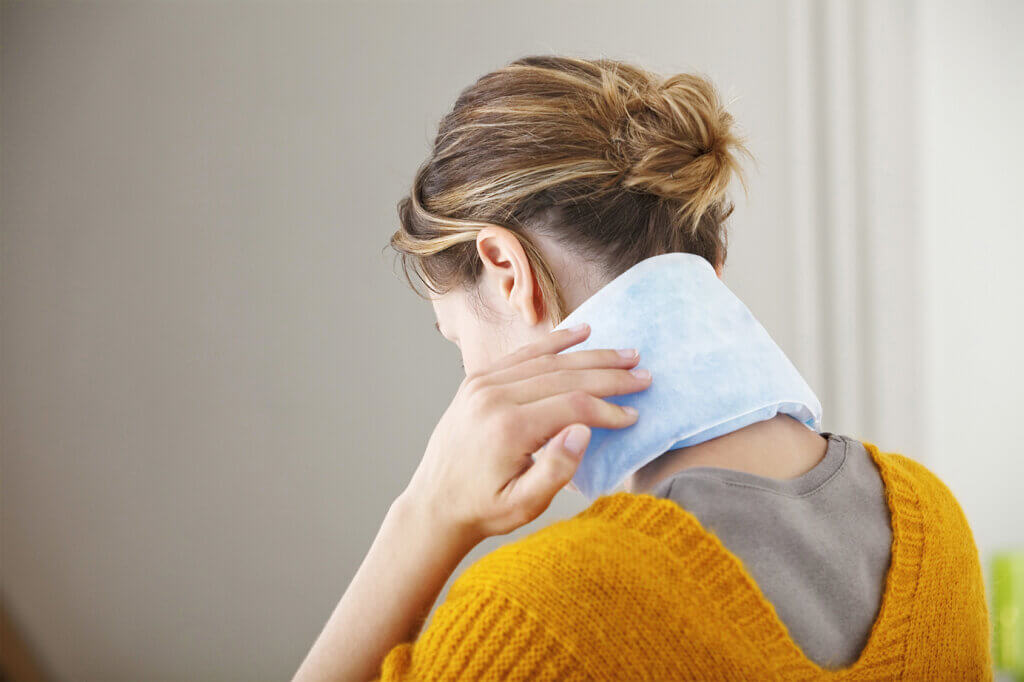 woman has heating pillow in neck