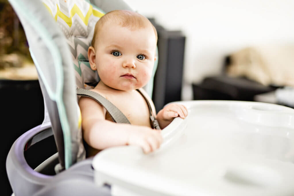 child sitting in the high chair