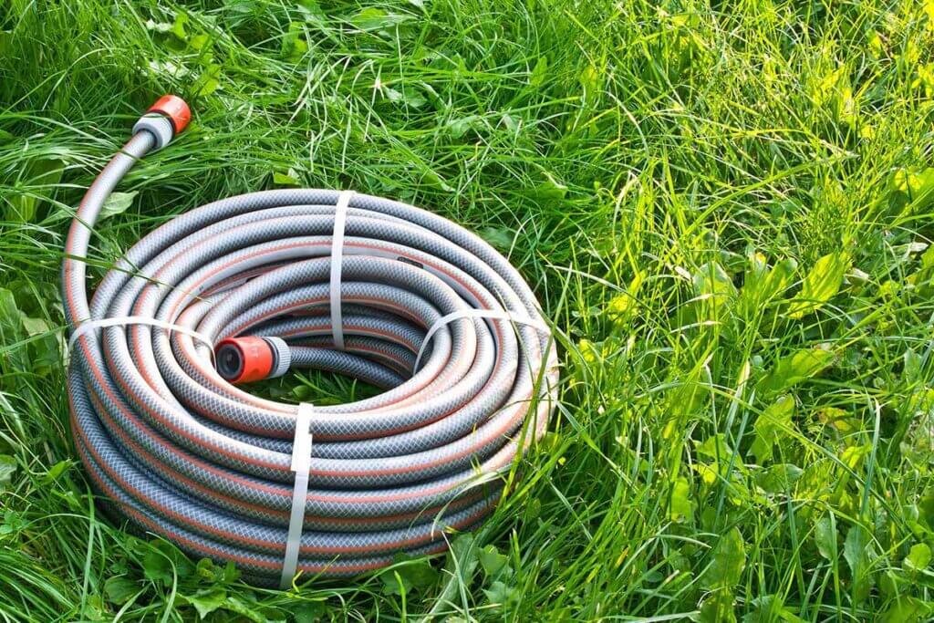 New garden hose lies on lawn