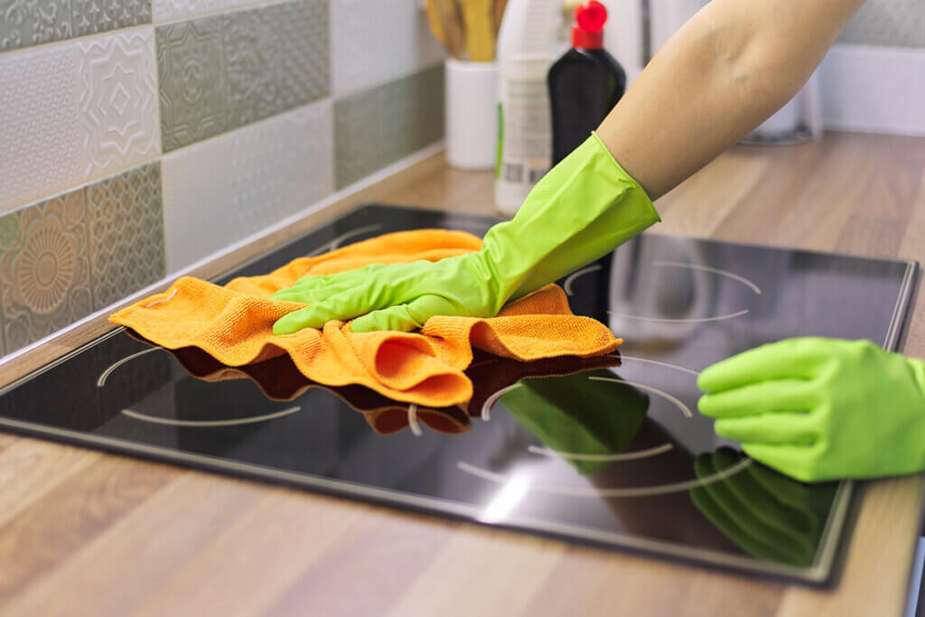 Woman cleaning the hob