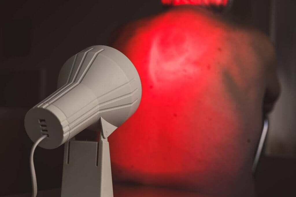 red light lamp - round lamp irradiates man's back and neck