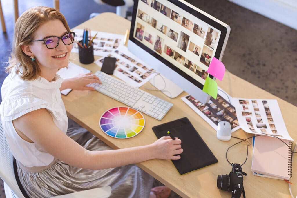 woman sits at the pc and edits images