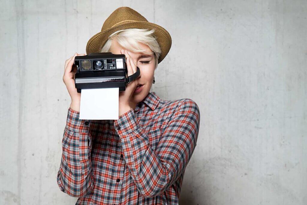 boy takes photo with an instant camera