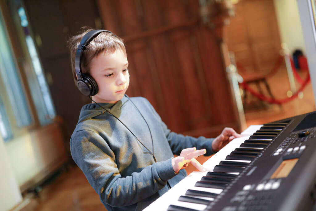 boy plays keyboard