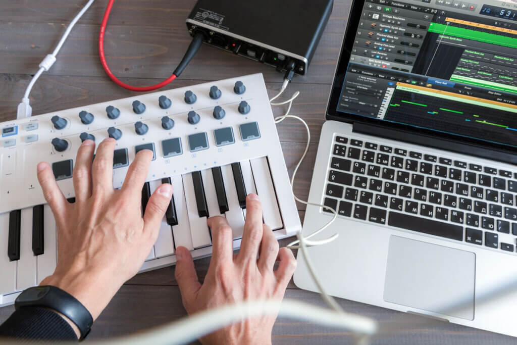 music production with notebook and keyboard