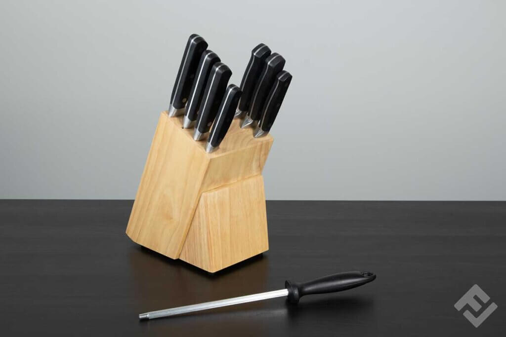 Fully equipped wooden knife block on a black table