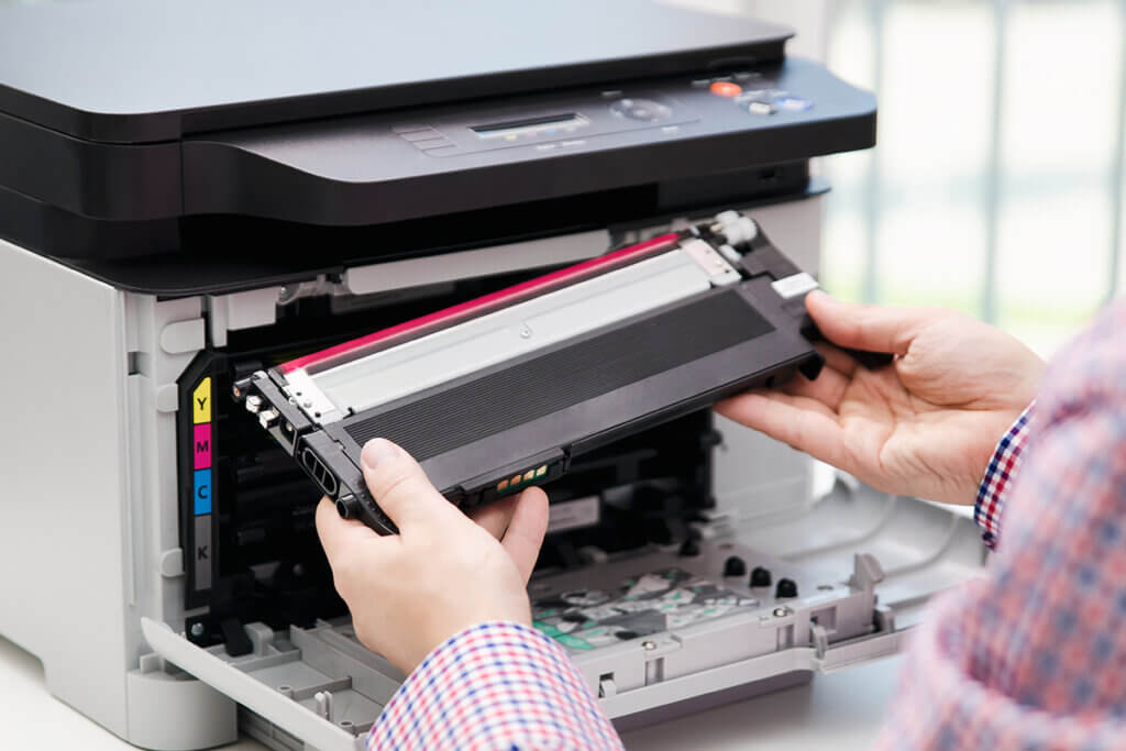  Man replaces toner in a multifunction printer.