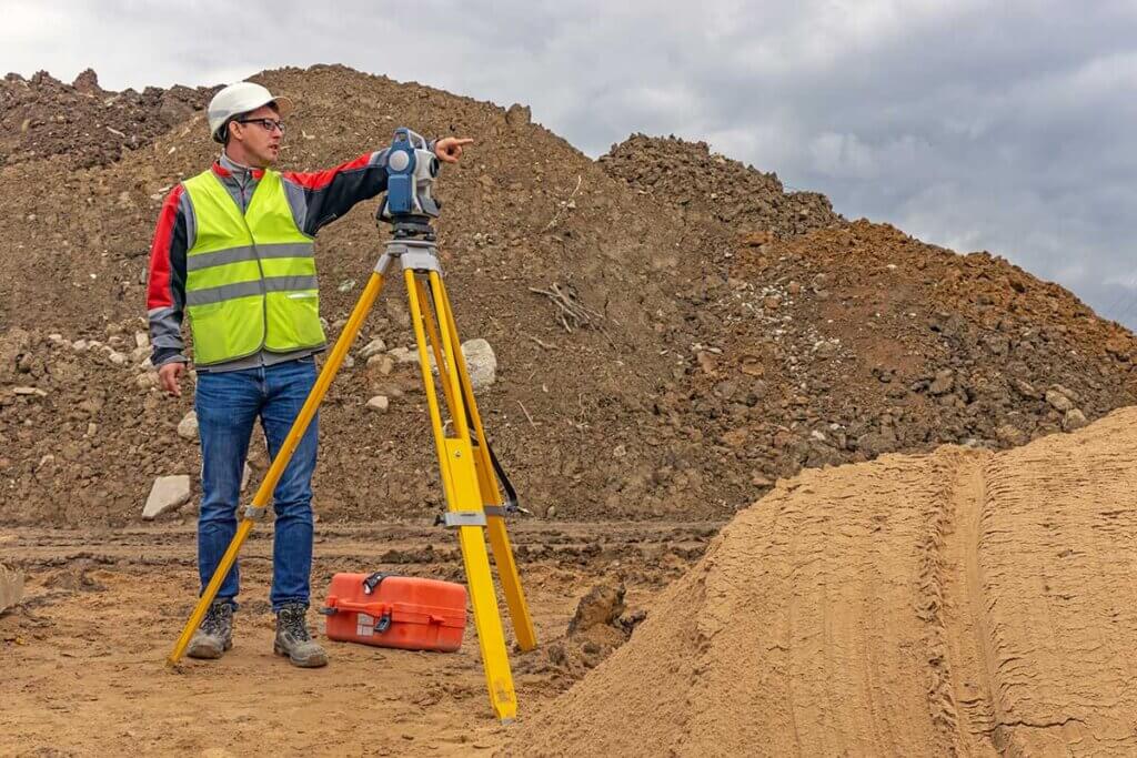  Worker uses laser rangefinder on construction site