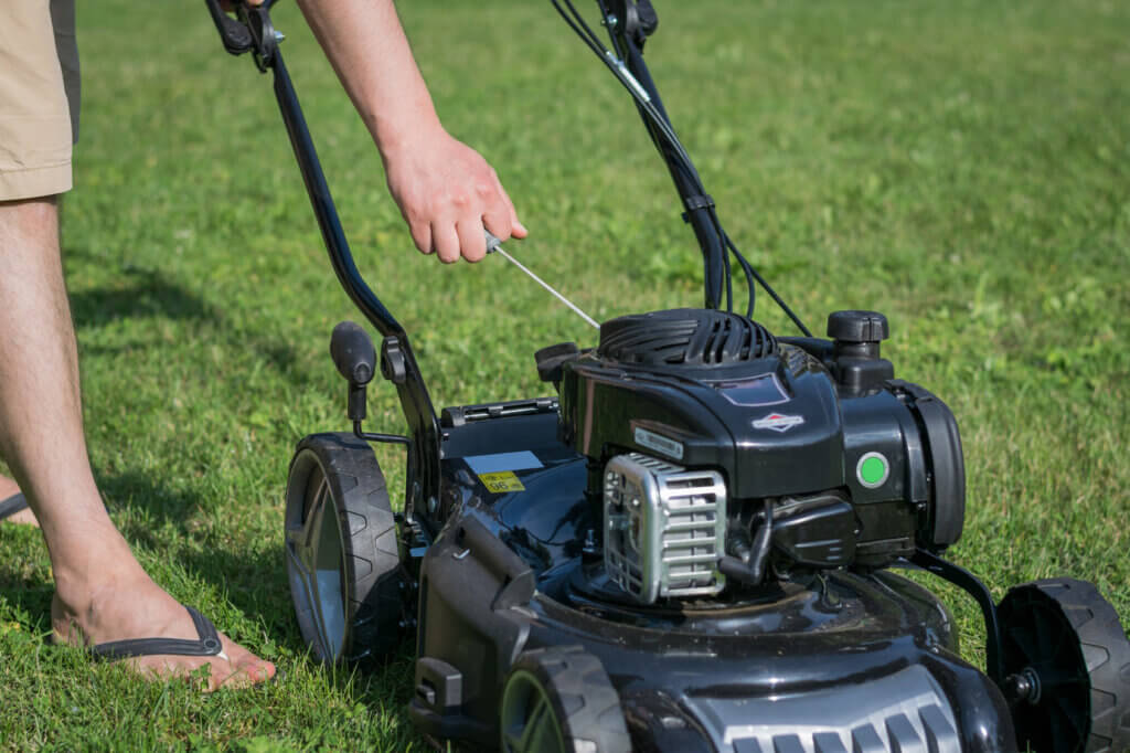 man starts lawn mower